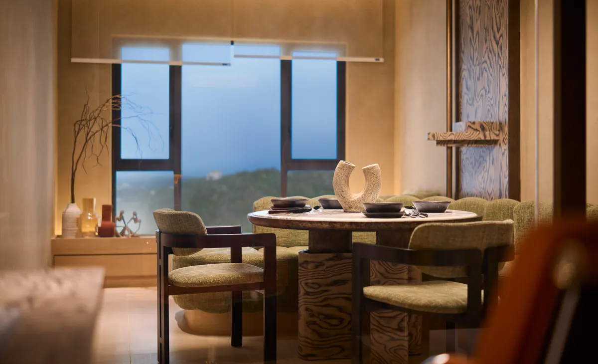 Type A dining setting at the window, hills and sky beyond